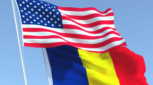 Two waving state flags of United States and Romania on the blue sky. High - quality business background. 3d illustration