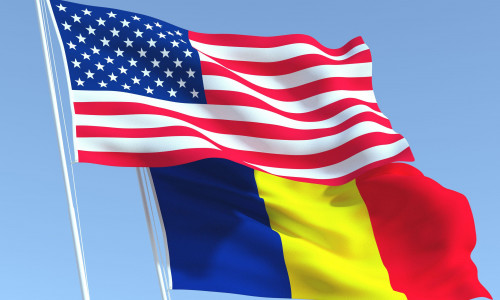 Two waving state flags of United States and Romania on the blue sky. High - quality business background. 3d illustration