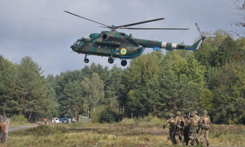 Ukrainian soldiers and ukrainian helicopter during a joint military exercise Rapid Trident 2019 at a at the International Center for Peacekeeping and Security of the National Academy of Land Forces near Lviv.