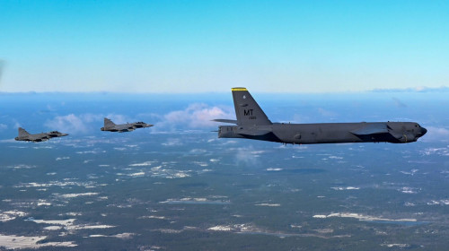 A B-52H Stratofortress from the 69th Expeditionary Bomb Squadron at RAF Fairford, England is escorted by two Swedish Saab JAS 39 Gripens, Feb. 18, 2022. The Swedish fighters met with the B-52 during a sortie over Sweden to practice establishing communicat