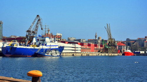 Colorful morning on the shore of the Black sea at Constanta Maritime Harbor, Romania. Old Town in the background.