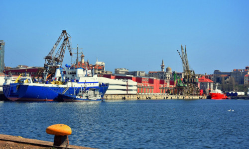 Colorful morning on the shore of the Black sea at Constanta Maritime Harbor, Romania. Old Town in the background.