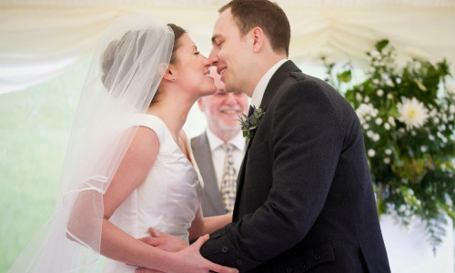 Newlywed couple kissing in wedding