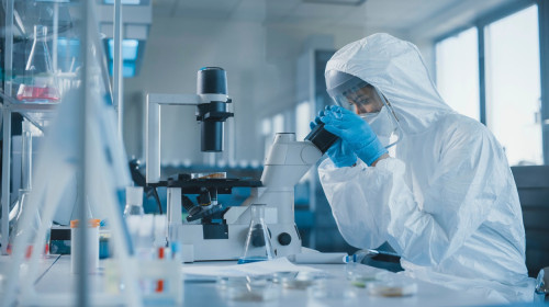 Scientist using a microscope in a laboratory