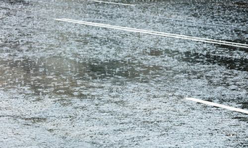 city road flooded with water during heavy rain