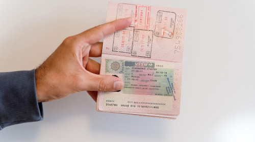 Russian passport in the hands of a man. Prohibition of Schengen visas for Russian tourists to travel to the European Union concept. High quality photo