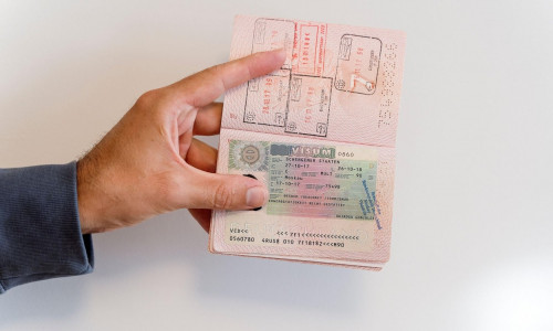 Russian passport in the hands of a man. Prohibition of Schengen visas for Russian tourists to travel to the European Union concept. High quality photo