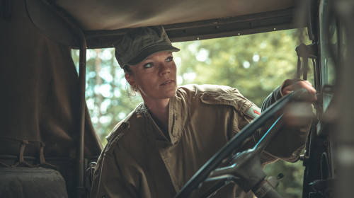 woman in a military uniform in an army car