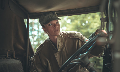 woman in a military uniform in an army car