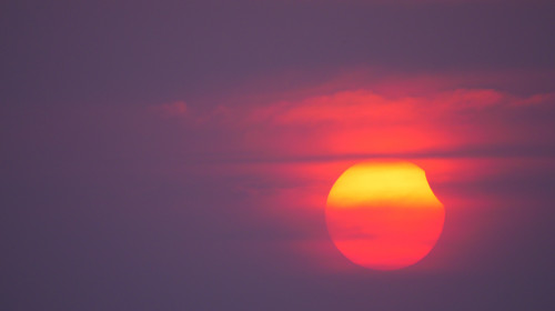 Partial,Solar,Eclipse,On,A,Cloudy