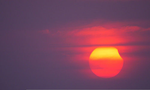 Partial,Solar,Eclipse,On,A,Cloudy