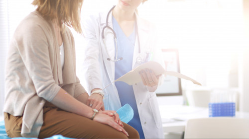 Doctor,And,Patient,Discussing,Something,While,Sitting,At,The,Table