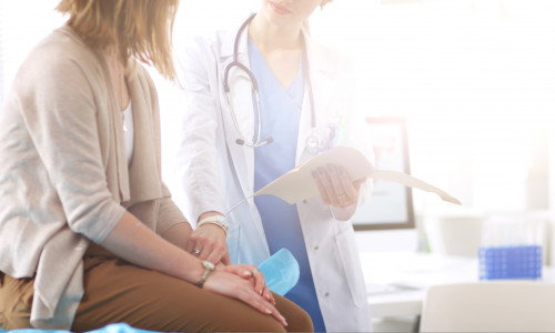 Doctor,And,Patient,Discussing,Something,While,Sitting,At,The,Table