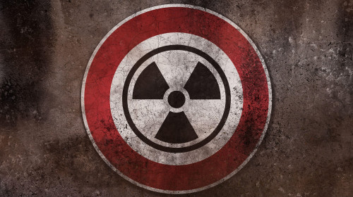 Nuclear Danger Warning Sign On A Wall, Warning Of Radioactivity, Radiation And Nuclear Weapons PHOTOMONTAGE