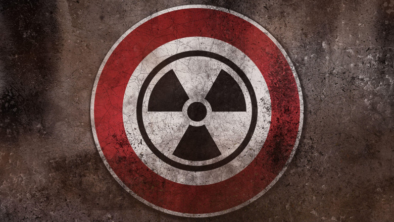 Nuclear Danger Warning Sign On A Wall, Warning Of Radioactivity, Radiation And Nuclear Weapons PHOTOMONTAGE