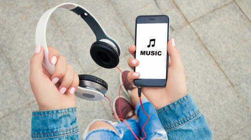 Hands,Of,A,Young,Girl,Holding,Headphones,And,Phone,.