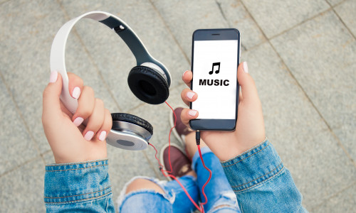 Hands,Of,A,Young,Girl,Holding,Headphones,And,Phone,.