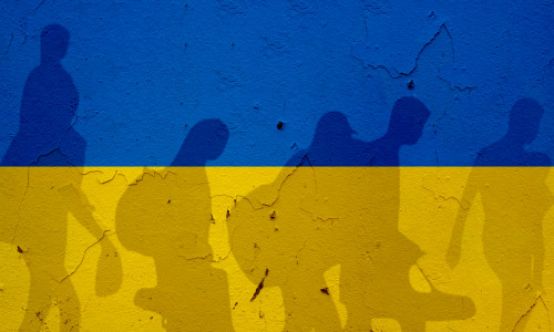 Ukraine,Flag,On,Wall,And,Refugee,Shadows.,Ukraine,War,Concept.