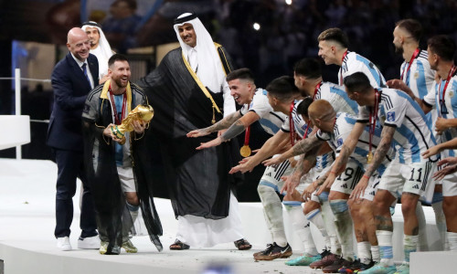 Argentina's forward Lionel Messi holds up the FIFA World Cup Trophy as he celebrates with teammates winning the Qatar 2022 World Cup final football match between Argentina and France, Doha, Qatar - 18 Dec 2022