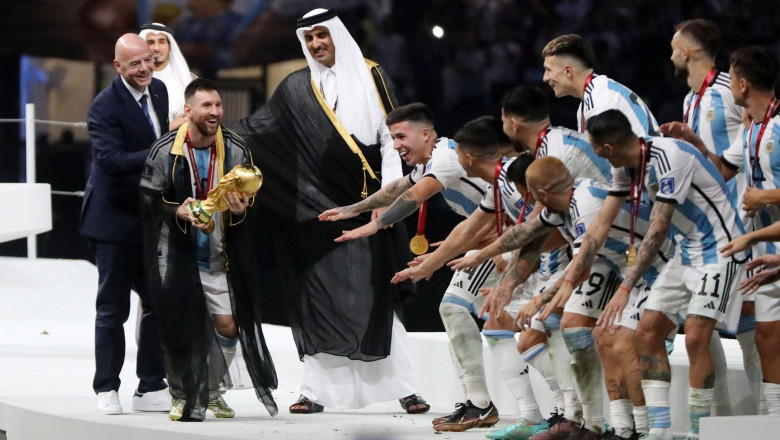 Argentina's forward Lionel Messi holds up the FIFA World Cup Trophy as he celebrates with teammates winning the Qatar 2022 World Cup final football match between Argentina and France, Doha, Qatar - 18 Dec 2022