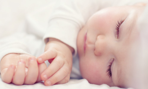 Close-up,Portrait,Of,A,Beautiful,Sleeping,Baby,On,White