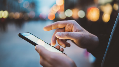 Close-up,Image,Of,Male,Hands,Using,Smartphone,At,Night,On