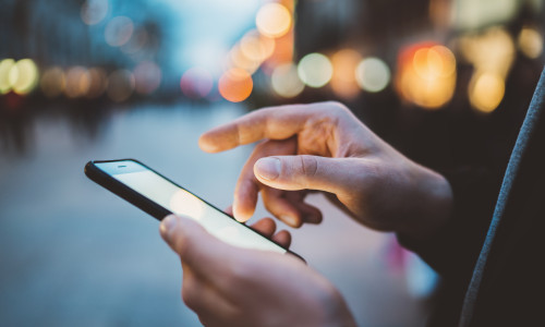 Close-up,Image,Of,Male,Hands,Using,Smartphone,At,Night,On