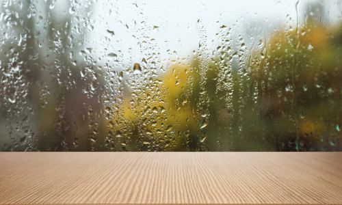 Wooden,Table,Near,Window,On,Rainy,Day