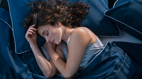 Top,View,Of,Young,Woman,Sleeping,On,Side,In,Her