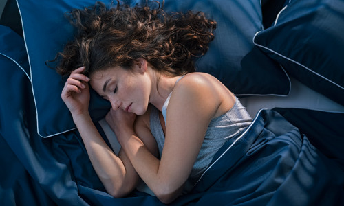 Top,View,Of,Young,Woman,Sleeping,On,Side,In,Her