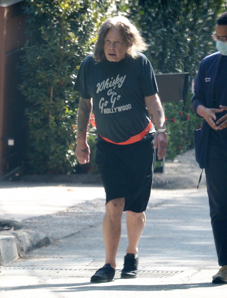 EXCLUSIVE: Ozzy Osbourne is Pictured on a Walk With The Help of an Aide in Los Angeles.