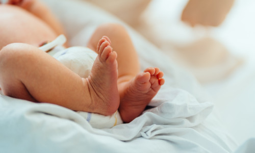 New,Born,Baby,Feet,On,White,Blanket,In,Hospital