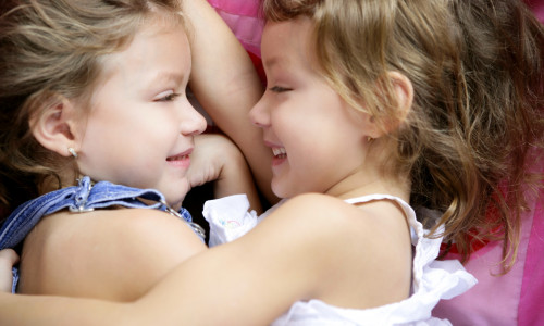 Two twin sisters in a hug, close up