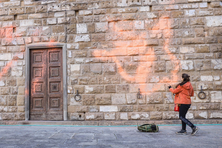 Italy, Florence: Members of Ultima Generazione, Last Generation climate civil-disobedience group, spray paint over Palazzo Vecchio next to the David masterpiece of Renaissance sculpture created by the Italian artist Michelangelo Buonarroti