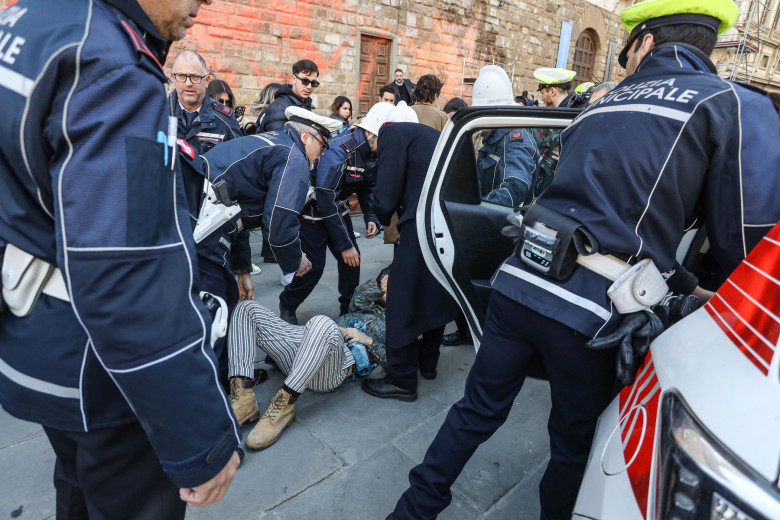 Italy, Florence: Members of Ultima Generazione, Last Generation climate civil-disobedience group, spray paint over Palazzo Vecchio next to the David masterpiece of Renaissance sculpture created by the Italian artist Michelangelo Buonarroti