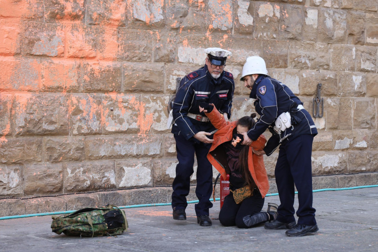 Italy, Florence: Members of Ultima Generazione, Last Generation climate civil-disobedience group, spray paint over Palazzo Vecchio next to the David masterpiece of Renaissance sculpture created by the Italian artist Michelangelo Buonarroti