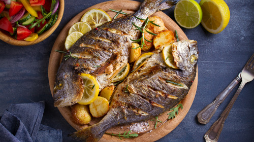 Roasted,Fish,And,Potatoes,,Served,On,Wooden,Tray.,Overhead,,Horizontal