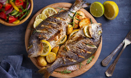 Roasted,Fish,And,Potatoes,,Served,On,Wooden,Tray.,Overhead,,Horizontal