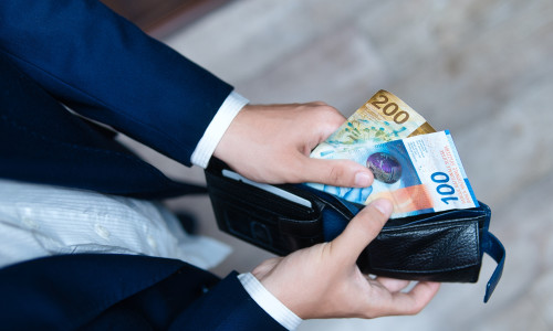 A,Businessman,Holds,A,Wallet,Filled,With,Swiss,Francs,In