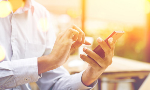 Indian,Businessman,Using,Smartphone,At,Outdoor,Cafeteria,,Beautiful,Blurred,Golden