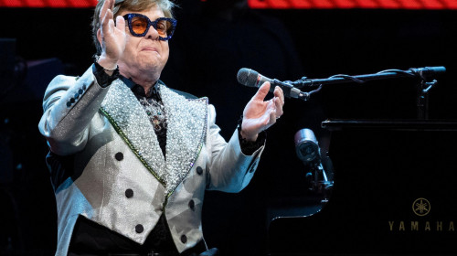 Munich, Germany. 27th Apr, 2023. Singer and pianist Elton John sits on stage at the Olympiahalle during a concert as part of his 