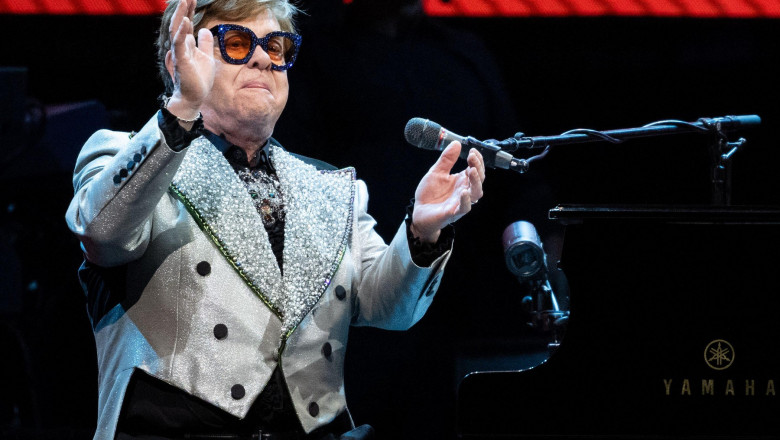 Munich, Germany. 27th Apr, 2023. Singer and pianist Elton John sits on stage at the Olympiahalle during a concert as part of his "Farewell Yellow Brick Road Tour 2023". Credit: Sven Hoppe/dpa - ATTENTION: Only for editorial use and only with full mention