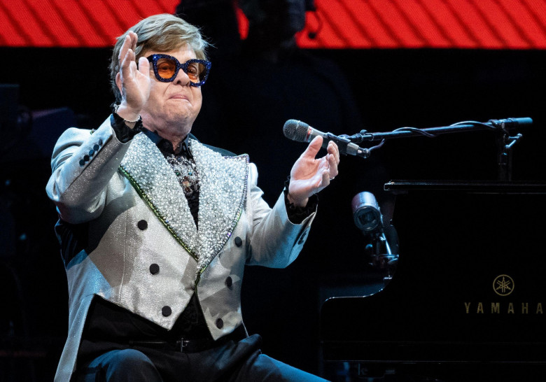 Munich, Germany. 27th Apr, 2023. Singer and pianist Elton John sits on stage at the Olympiahalle during a concert as part of his "Farewell Yellow Brick Road Tour 2023". Credit: Sven Hoppe/dpa - ATTENTION: Only for editorial use and only with full mention