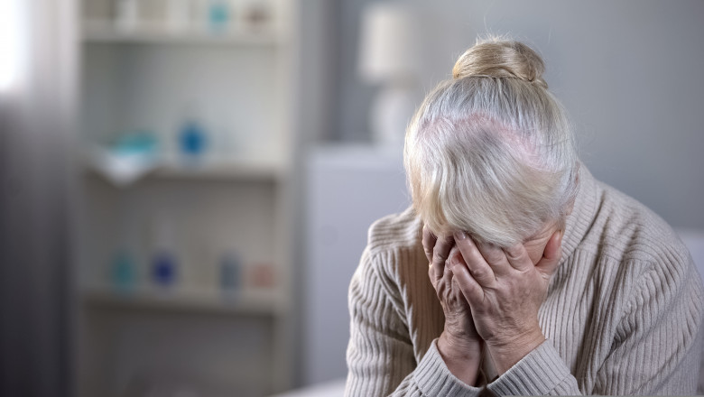 Unhappy,Elderly,Lady,Sitting,Alone,In,Living,Room,And,Deeply