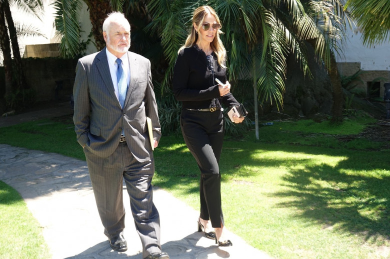 *EXCLUSIVE* Christine Baumgartner smiles leaving the latest hearing in her divorce battle with Kevin Costner