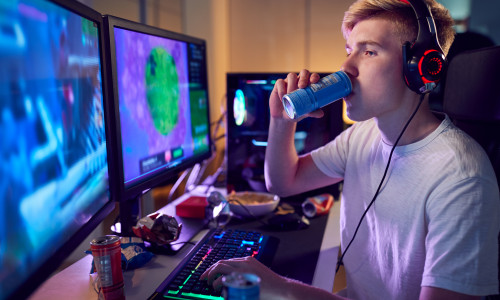 Teenage,Boy,Drinking,Caffeine,Energy,Drink,Gaming,At,Home,Using