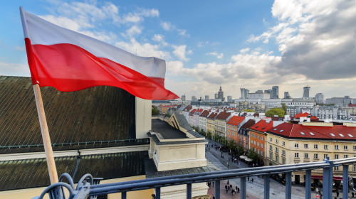 Poland,Flag,In,Blue,Sky,And,The,Centre,Of,Warsaw