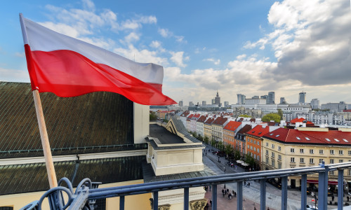 Poland,Flag,In,Blue,Sky,And,The,Centre,Of,Warsaw