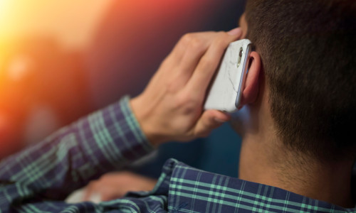 Closeup,Mobile,Phone,In,The,Ear,Listening,And,Talking