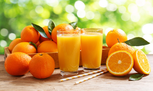 Glasses,Of,Fresh,Orange,Juice,With,Fresh,Fruits,Over,A